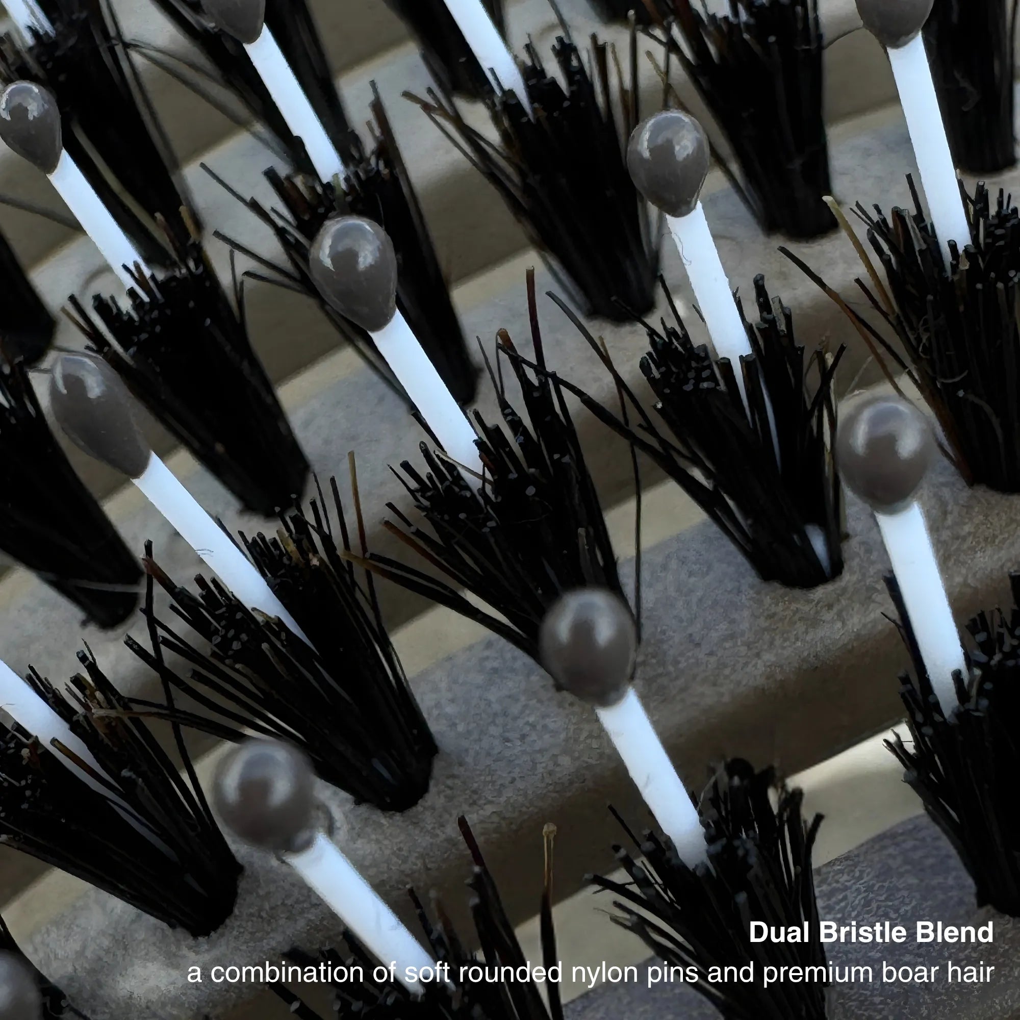 Close-up of ZIGZAG Brush dual bristle blend with soft rounded nylon pins and 100% boar hair.