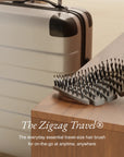 ZIGZAG Travel Hair Brush next to suitcase, the perfect hair brush for travel and life on the go.